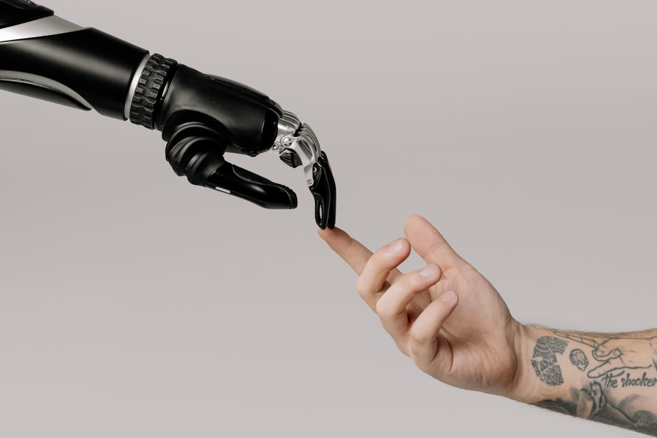 Crafting Captivating Headlines: Your awesome post title goes here A human hand with tattoos reaching out to a robotic hand on a white background.